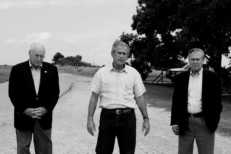 Flanked by U.S. Vice President Dick Cheney and Secretary of Defense Donald Rumsfeld, U.S. President George W. Bush addresses reporters on a road outside his ranch in Crawford, Texas, August 23, 2004. Photo By: Christopher Morris / VII