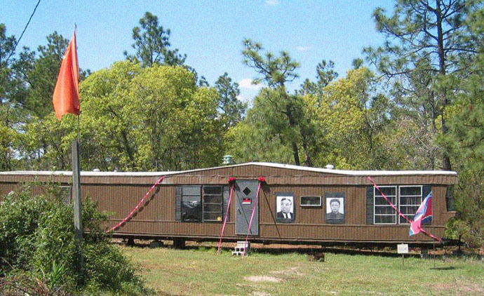 Sutter's South Carolina trailer with banners with the portraits of the leaders of North Korea