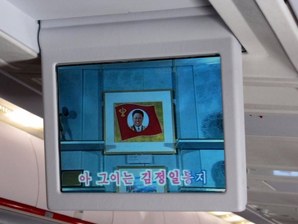 Flipdown TV screens with homages to Kim (Sr) (Jr) )3rd) for passenger entertainment