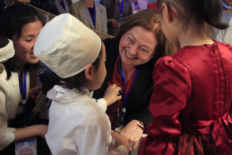 Nobel Peace Prize laureate Mairead Maguire, center, greets children at Kyongsang kindergarten in Pyongyang Wednesday, May 20, 2015. A group of female peace activists including Gloria Steinem and two Nobel laureates arrived in North Korea's capital on Tuesday for a march across the Demilitarized Zone that they hope will bring world attention to calls for a resolution to tensions on the Korean Peninsula. (AP Photo/Kim Kwang Hyon)