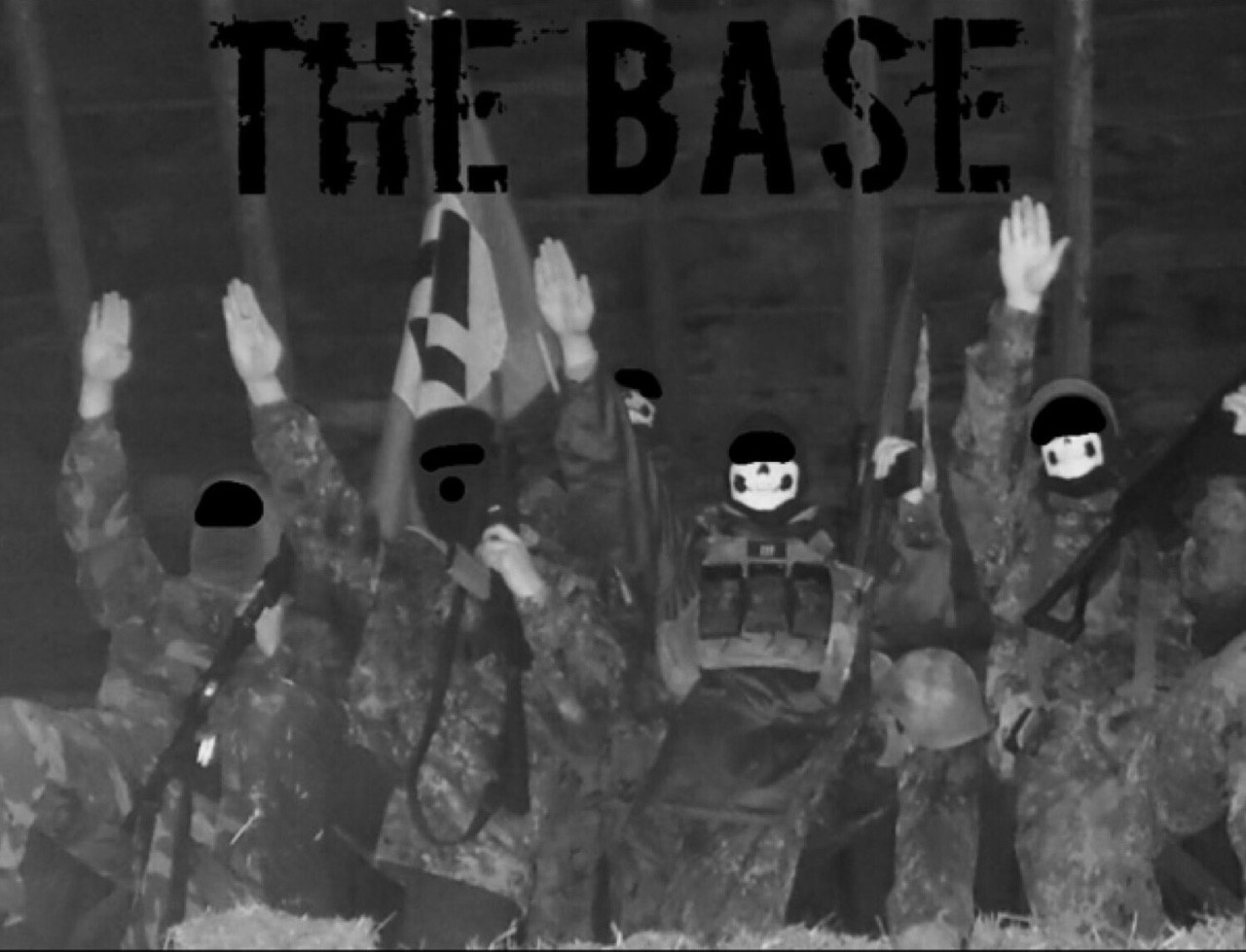 A group of masked individuals in camouflage gear performing Nazi salutes in front of a swastika flag, with the text 'THE BASE' overlaid at the top.