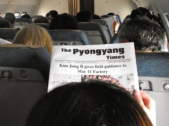 he attendants pass out a propaganda paper before getting off the ground. Guess who's on the front page