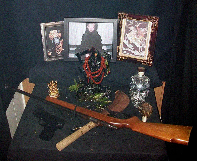 Sutter who can be seen in photo center in background. As a convicted felon, Sutter is prohibited from possessing firearms