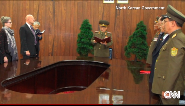 U.S. Director of National Intelligence James Clapper (l) at release ceremony of U.S. prisoners presided over by the North Korean head of secret police Kim Ho Wong