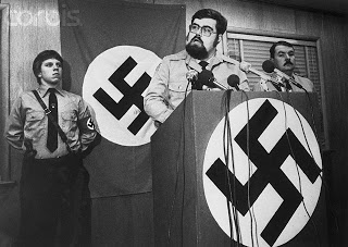 19 Nov 1980, Raleigh, North Carolina, USA --- Nazi leader Harold Covington holds a news conference 11/18 praising the acquittal of six Klansmen and Nazis charged with the slaying of five Communists. He called for North and South Carolina to secede from the Union and form a nation for whites only. Klan leader Gorrell Pierce (R) joined Covington at the conference. --- Image by © Bettmann/CORBIS