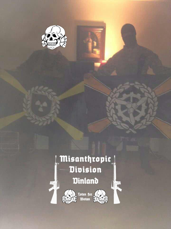 A photograph of two individuals in tactical gear holding flags with extremist symbols. One person's face is covered by a skull graphic, and the other wears a balaclava. Text at the bottom reads 'Misanthropic Division Vinland'.