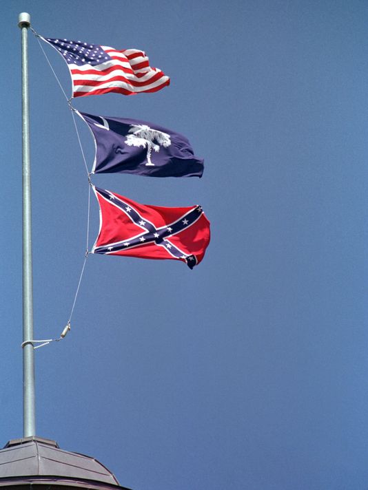 Flags flying over the South Carolina capital in 2000, when the Confederate flag was removed. In center is the South Carolina state flag. Bottom is one version of the Confederate flag
