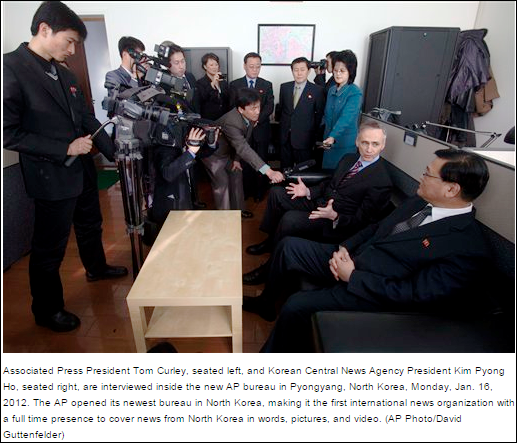 AP and NK officials open AP news bureau in Pyongyang, January, 2012. Rear center is the North Korean official from the Ministry of Foreign Affairs who AP pays directly in hand couriered cash payments of $12,000 a month the salaried of the AP news reporters they were ordered to hire by the regime.